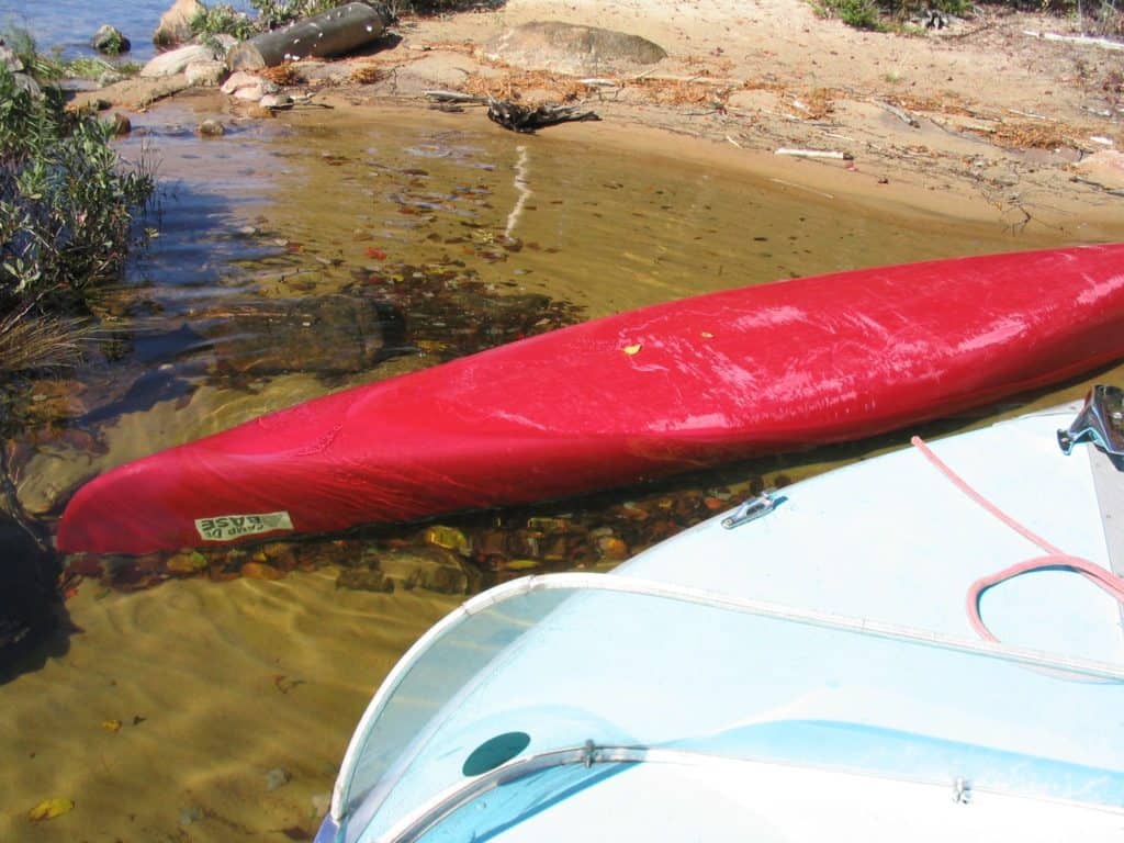 Capsized Red Canoe in the Shallows