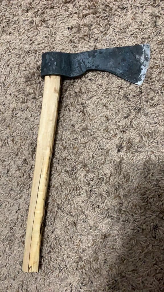 Hand-forged tomahawk laying on the carpet