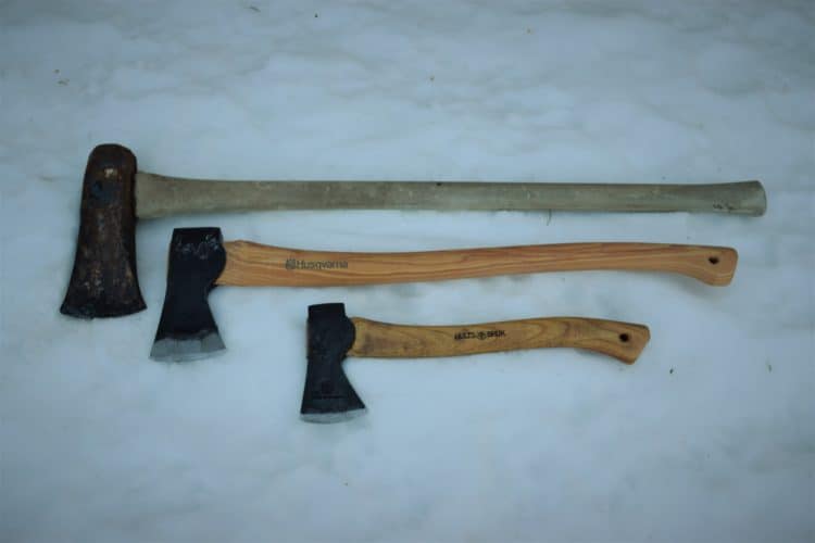 Splitting Maul, Axe, and Hatchet lying in the snow