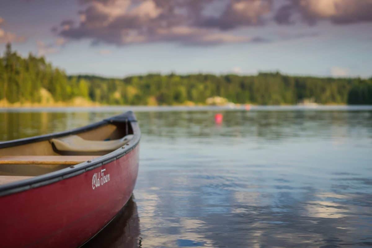 Red canoe on beautiful lake