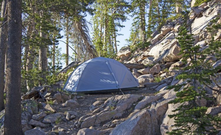 Tent staked out on a rocky slope