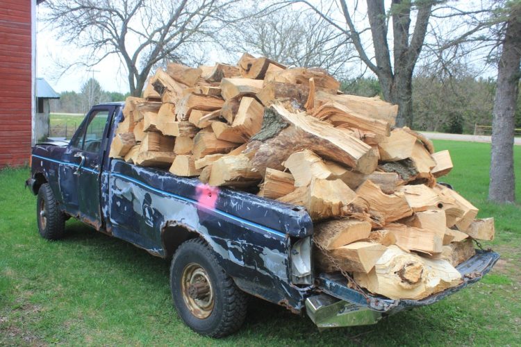 Firewood overflowing pickup truck